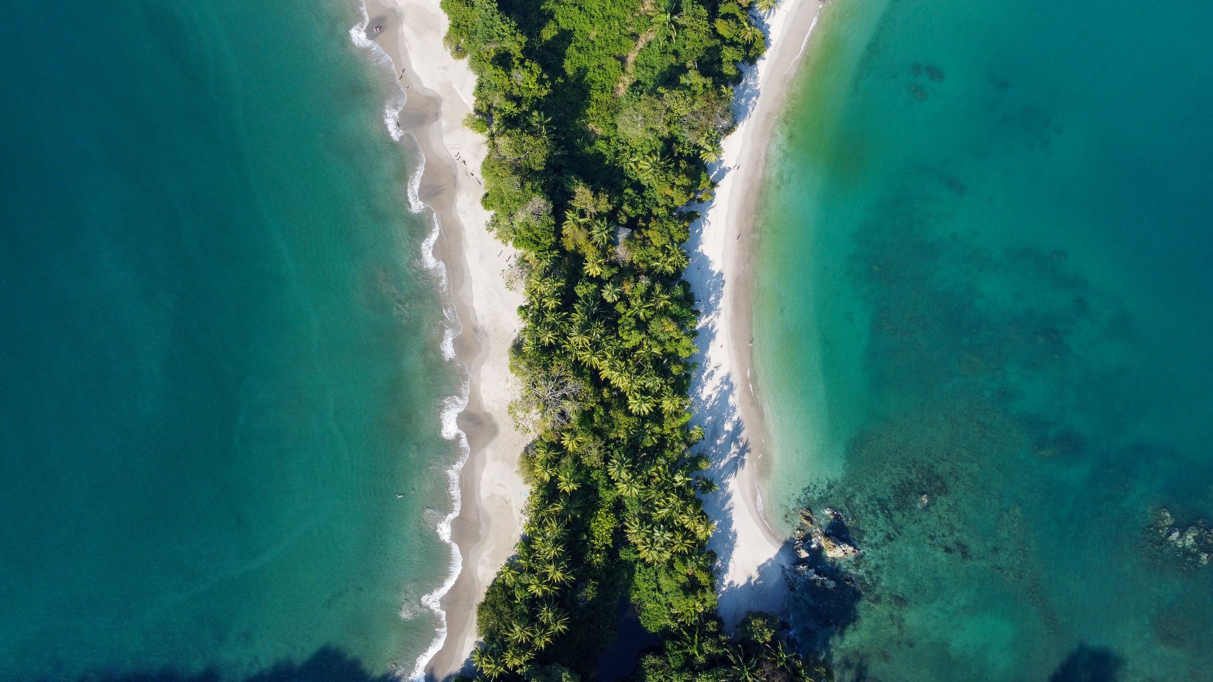Aerial view of Manuel Antonio Beach, where rainforest meets the Pacific Ocean